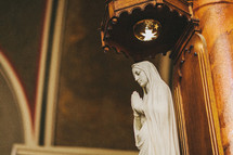 Indoor statue of a praying Mary.