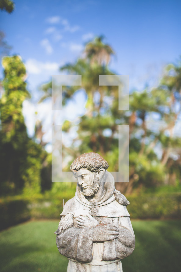 Statue of St. Francis of Assisi in a garden.