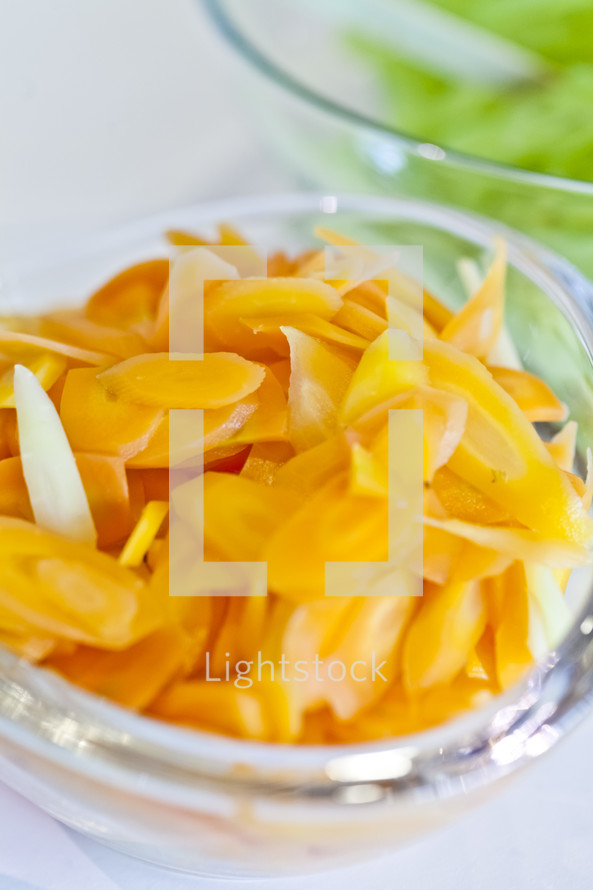 A bowl of sliced carrots.