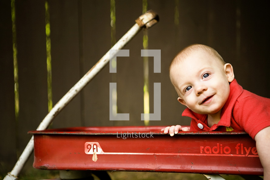 infant boy sitting in a wagon