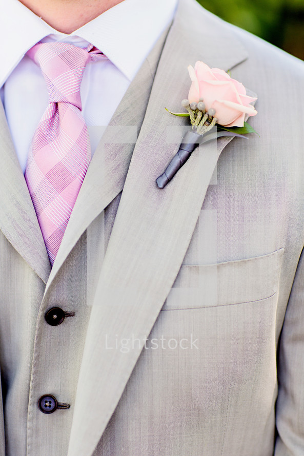 Mans grey suit with pink checker tie pink rose boutonnière 