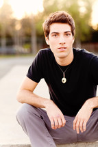 Young man sitting teen model fashion brown hair Caucasian white