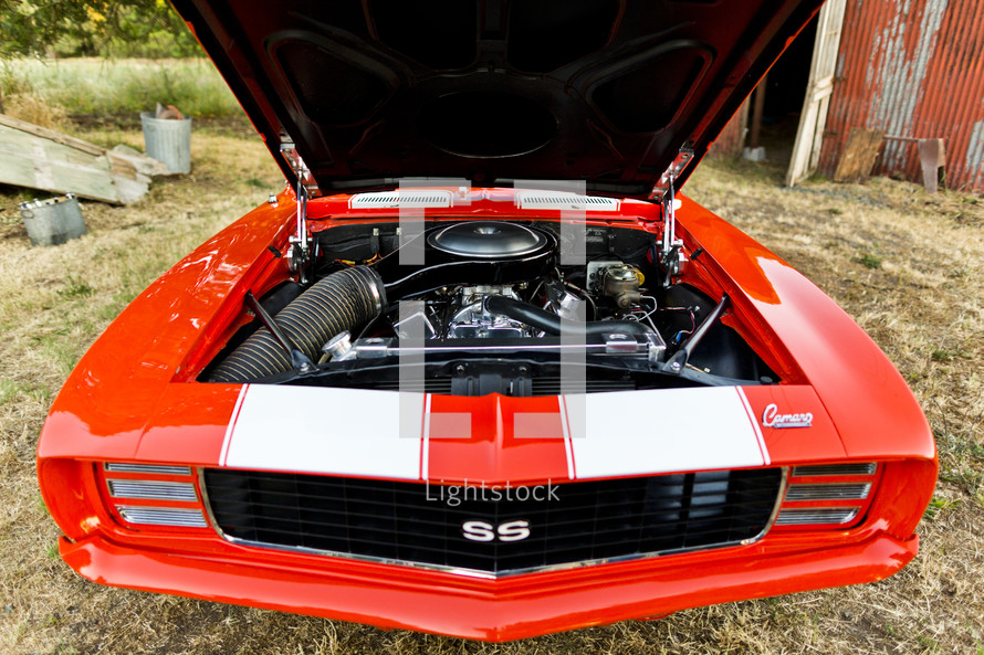 engine in a classic Chevrolet Camaro car SS Super Sport, Orange muscle car