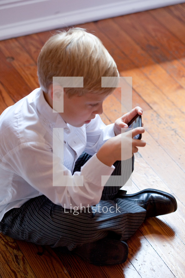 boy playing games on a cellphone
