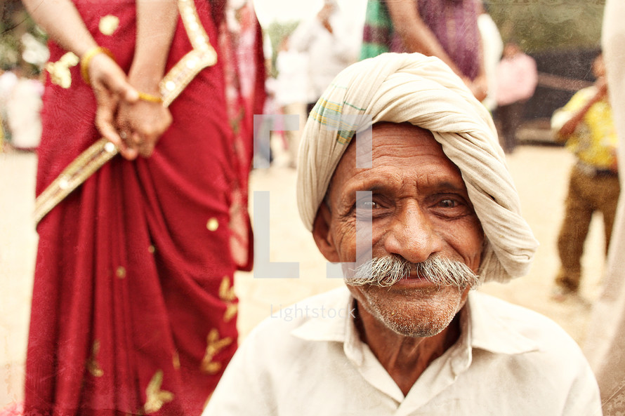 man with a mustache in India smiling