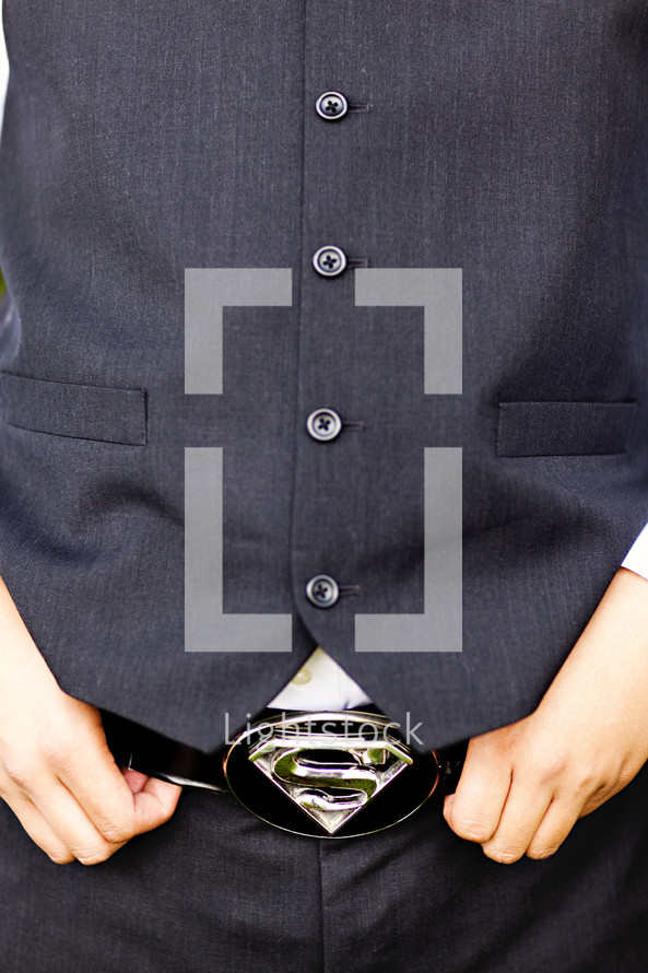 buttons on a vest with a superman belt buckle 