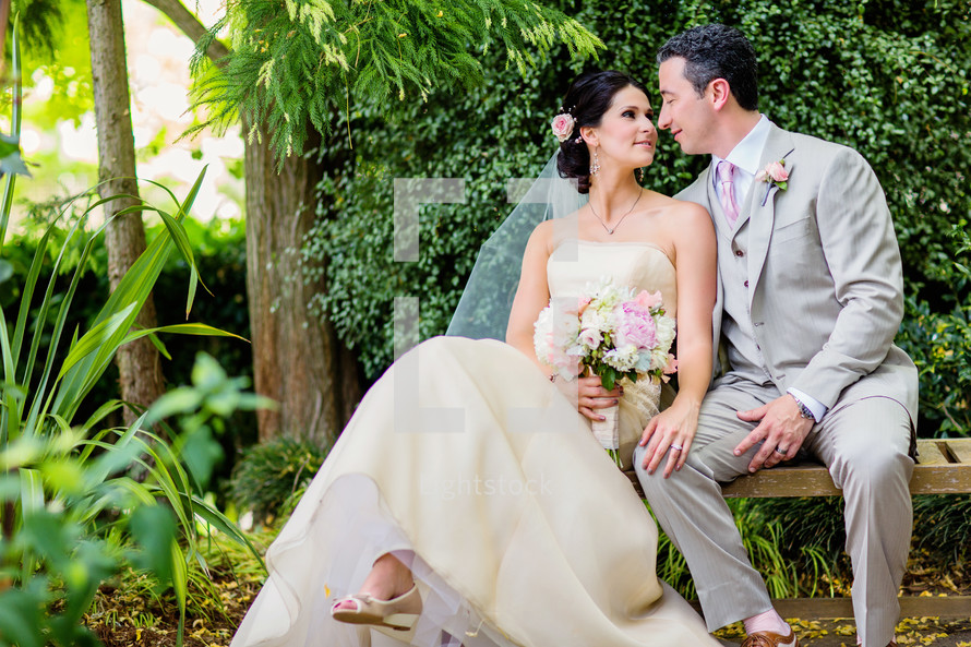 A bride and groom sitting on a bench  love wedding man and wife