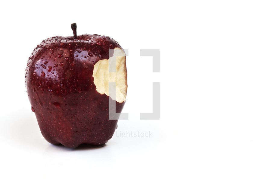 Bite out of an apple isolated on white