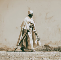 man walking across a desert in Africa 