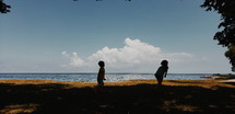 silhouette of kids on a beach 