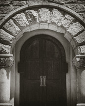 stone arch over a wood door 