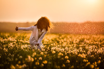 girl in a field of dandelions 
