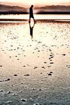 a man walking across a salt lake 