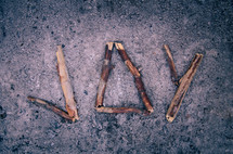the word "joy" made with sticks