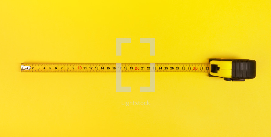 measuring tape on a yellow background 