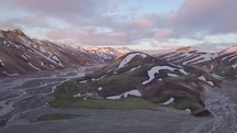 Aerial view of rainbow volcanic mountains in evening in Iceland
