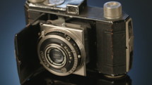 Antique camera on a shiny black surface
