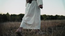 Jesus walking in a field 