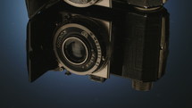 Antique camera on a shiny black surface