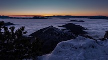 Beautiful view of winter sunrise in wild snowy mountains landscape with low foggy clouds in valley nature Time-lapse 
