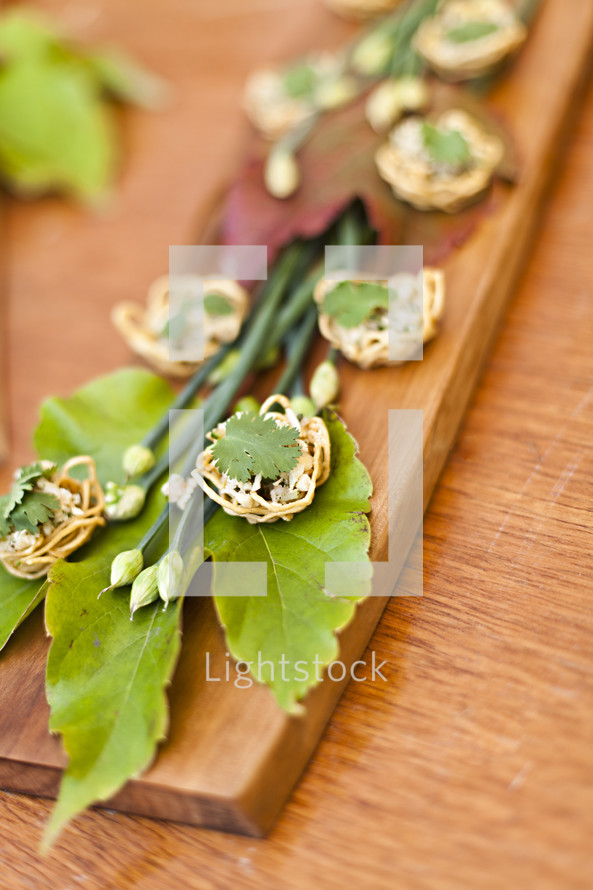 Appetizer Arrangement on wooden block and green leaves