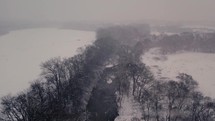 snow falling over a river 