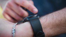 Man Uses Black Smartwatch On Wrist