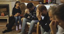 People praying in a living room
