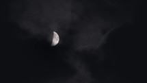 Scenic view of moon in the first quarter surrounded by misty atmospheric clouds