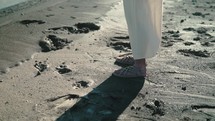 Jesus walking on a beach