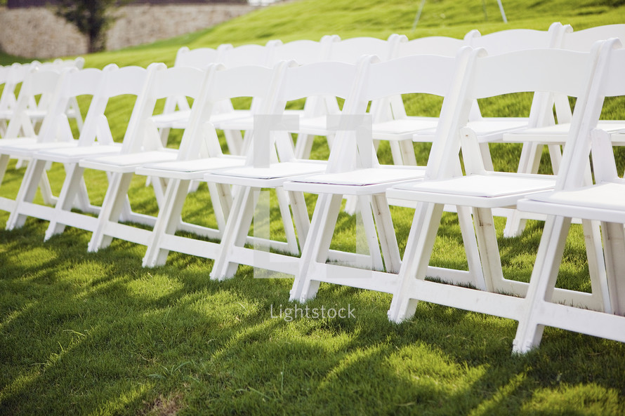 row of white folding chairs