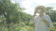 Senior caucasian woman gardening in her garden themes of retirement relaxing seniors portraits drinking
