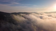 Fly above foggy clouds, Aerial view of beautiful nature colors in sunny autumn morning heaven misty 4K
