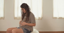 Pregnant woman rubbing her belly.