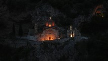 Illuminated monastery in the mountain at night