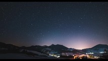 Starry night sky stars in mountains countryside Astronomy Time-lapse Night to day
