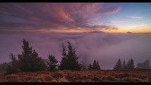 Mystic sunrise in alpine mountains landscape above foggy clouds sky in sunny autumn morning Time lapse 4K nature