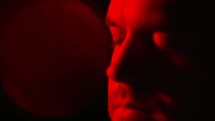 face of a man in red light 