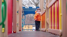 Little boy on playground equipment