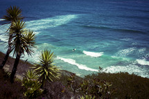 view of a surfer from a cliff 