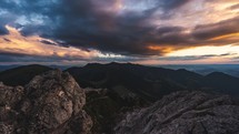 Time lapse of Dark dramatic clouds sky in evening alps mountains nature at sunset