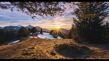 Time-lapse of Beautiful sunset sky under tree in early spring nature mountains landscape
