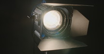 Film light switching on and creating a lens flare.