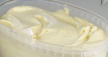 Ice cream scoop scooping mango flavored soft ice cream