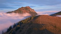 Peaceful Aerial view of autumn mountains in foggy nature at sunset magic
