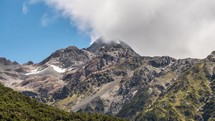 Clouds moving over alpine mountain peak in New Zealand south alps landscape Time-lapse

