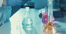 Slow motion of lab Technician mixing chemicals in a lab