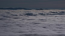 Beautiful view above blue clouds in foggy mountain valley nature time lapse
