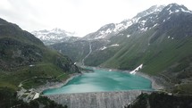 a turquoise lake and dam in Switzerland 