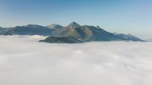 Aerial flight above clouds in mountains in autumn morning landscape time lapse hyper-lapse
